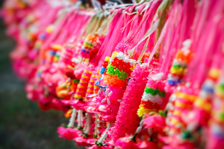 Many beautiful fake pink garlands hung on the sticks.の素材
