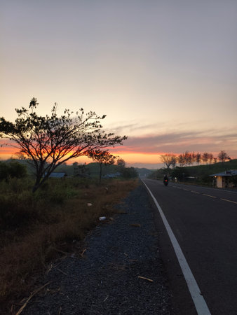 Sunset on the road in the countryside of Indonesia, long exposureの写真素材
