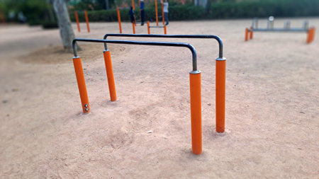 Empty parallel bars for dips and muscle-ups inviting people to exercise outdoors