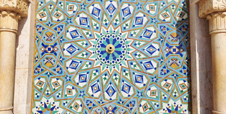 Intricate moroccan zellige tile mosaic adorns a fountain, showcasing vibrant colors and complex geometric star patternsの写真素材