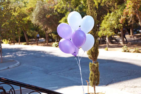 White and pink green balloons flying in the skyの写真素材