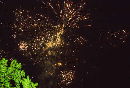 A photo of a salute in the night sky. Bright texture of festive fireworks. Abstract holiday background with various colors fireworks light. New Years, Christmas lights in the sky, colorful lights.の写真素材