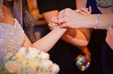 Hands of the bride and girlfriends. Touching the girls. Women's fees on the wedding day.の写真素材