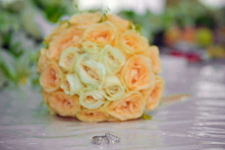 Yellow flower bouquet and rings for wedding. Yellow roses
