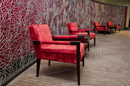 Luxury vintage red armchair on red backgroundの写真素材