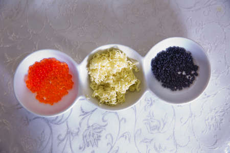Black caviar, Red caviar, butter in a bowlの写真素材