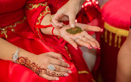 They put their hands henna of the bride . Drawing henna at the Henna party.の写真素材