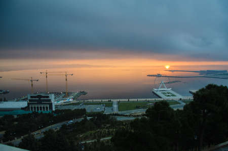 Sunset .The sun goes out on the edge of the Caspian Sea . Amazing view of clear sea landscape with cloudy sky as a background Sunset time. Baku, Azerbaijanの写真素材