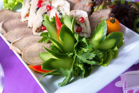 Cucumber flower and sausage, herbs. In the chopped sausage plateの写真素材