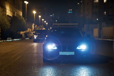 Road in the city at the night with yellow and red electrical light for cars during they are coming home. The cars compete at night. Only the lights of night carriages.の写真素材