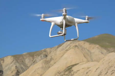 Drone quad copter with high resolution digital camera on the sky .White drone with digital camera...