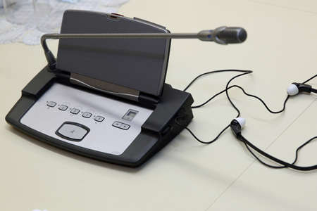 Soft focus of wireless Conference microphones and notebook in a meeting room. Before a conference,...