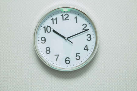 Time Punctual Second Minute Hour Concept . Wall white clock and shelf at abstract white background ....