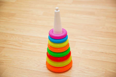 Educational toys for toddlers, gripping rings, isolated on yellow.