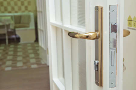 Close-up elements of the interior of the apartment. Detail of a white interior door with a door handle and latchの写真素材