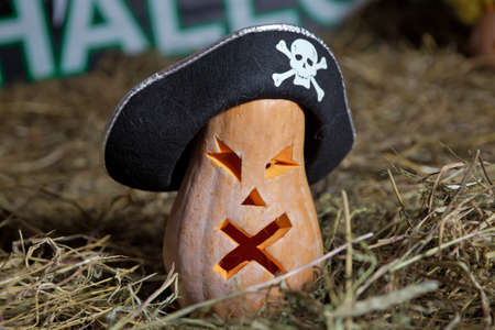 Halloween pumpkin grinning in the most evil fashion . Spooky Halloween Jack o Lantern . Pumpkin on dry straw in autumn on a background . In preparation for Halloweenの写真素材