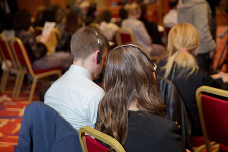 bald security guard with the headset to control people . heated debate at a conference discussion