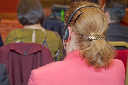 bald security guard with the headset to control people . heated debate at a conference discussionの写真素材