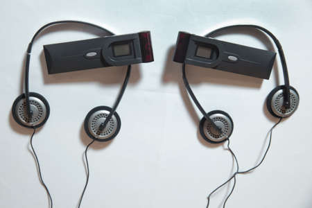 Headphones for simultaneous translation . wireless multy language headphones set on the chairs in...