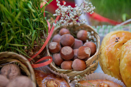 Hazel in a small basket . Close-up of hazelnuts as background . Mix of walnuts with hard shell . dried walnuts, closeup .の写真素材