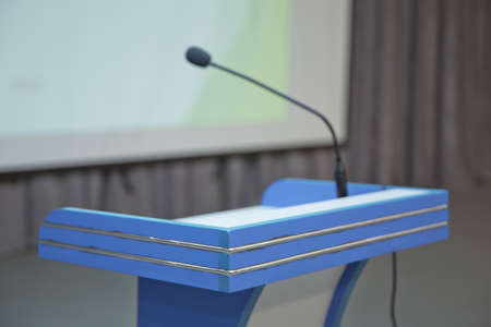 before a conference, the microphones in front of empty chairs. Close up of microphone in conference...