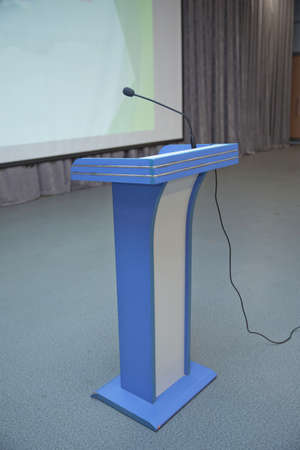 before a conference, the microphones in front of empty chairs. Close up of microphone in conference room . Microphone in Conference Seminar room Event Backgroundの写真素材