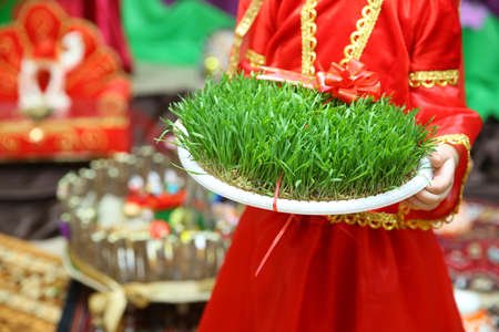 Navruz Nowruz holiday, the spring New Year holiday. He held his hand in green Semeni . Traditional fresh green grass samani - symbol of spring and Novruzの写真素材