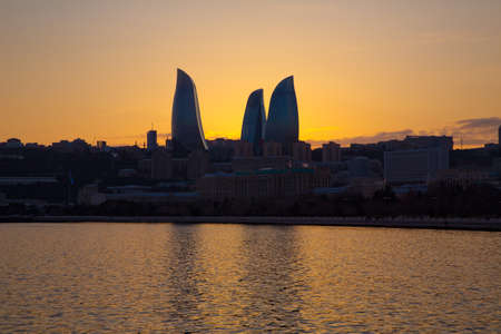 Baku, Azerbaijan - February 2, 2018: Night view of Baku with the Flame Towers skyscrapers, television tower and the seaside of the Caspian sea . The seaside of the Caspian sea . Sunsetの写真素材