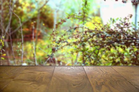 Autumn Wooden board empty table in front of blurred background . Empty wooden table in front of abstract blurred background of coffee shop .の写真素材