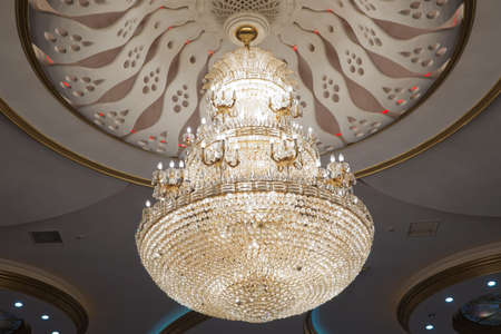 Big and old expensive crystal chandelier .illustration of a chandelier with crystal pendants on the...