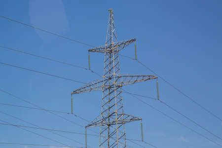 Electricity transmission power lines High voltage tower . Power line high voltage post with blue sky...