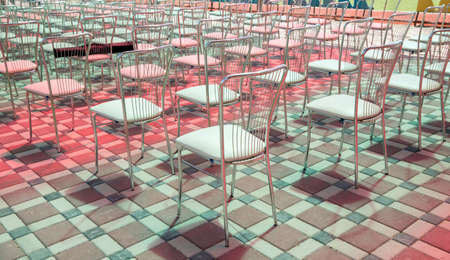 Empty chairs back view of an auditorium in a summer camp . Set of iron chairs . Rear view of the iron chairs.の写真素材