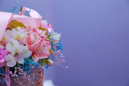 Bouquet of multicolored roses . Pink flower picture close up in the bouquet. Ribbon . Bouquet of fresh Pink, white , blue, orange roses .の写真素材