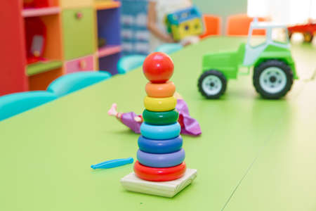 Educational toys for toddlers, gripping rings, isolated on yellow. Toy for babies and toddlers to joyfully learn mechanical skills and colorsの写真素材