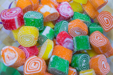 Macro photo food dessert jelly sweets. Texture background fruit jelly sweets candies. Image of fruit marmalade candy .Multicolored marmalade is located on a white background, horizontal photoの写真素材