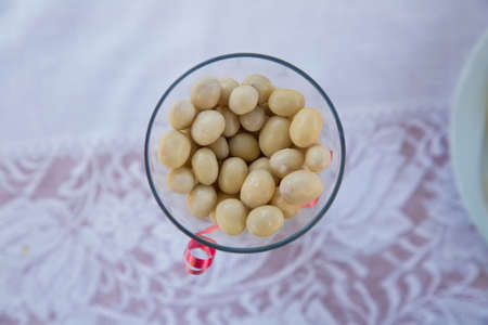 white chocolate balls with almond heart. in a glass jar .In a round white chocolate glass