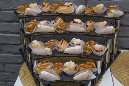 Ekler Pasta Chocolate Donut in plate. A lot of french dessert of profiteroles eclair choux pastry.
