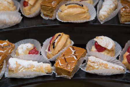 Ekler Pasta Chocolate Donut in plate. A lot of french dessert of profiteroles eclair choux pastry.