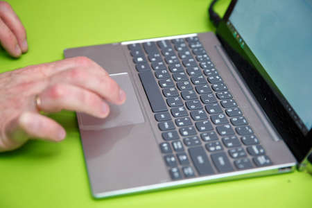 Close up picture of hand typing on keyboard of laptop or notebook, chatting online . Business man...