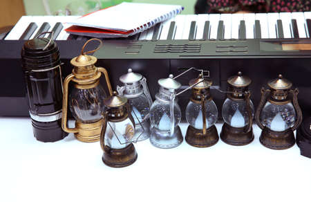 Vintage small old kerosene lamps on a wooden background . Old small oil Lamps in vintage,retro tone...
