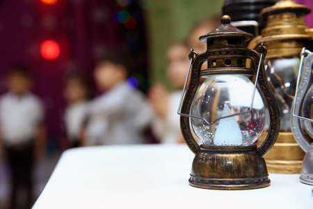 Vintage small old kerosene lamps on a wooden background . Old small oil Lamps in vintage,retro tone .の写真素材