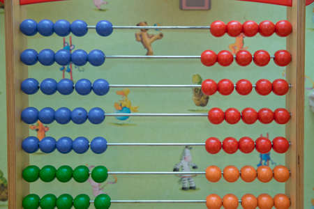 Traditional abacus with colorful wooden beads on white background. Toy abacus to learn counting....