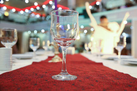 Empty glasses set in restaurant. Part of interior . wine glasses on the table in front of the empty...