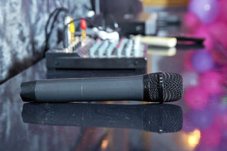 A black microphone is on the table .Close up Microphone on the table, concept of speaker or teacher...