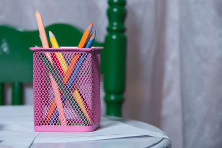 Box for pens and pencils . Colored pencils in a pencil case on white background . Color pencils in pink case on white background isolated . Creative concept shot of colorful pencilsの写真素材