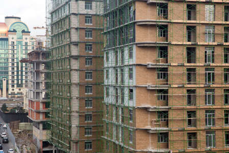 New building is being constructed. Large construction site including several cranes working on a...
