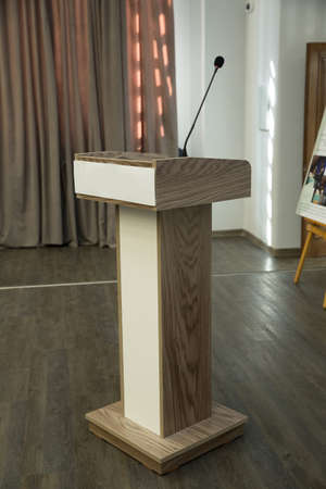 Wired microphone set up on the front of conference room close up with blurred background. Wired microphone close up with copy space . Close up of microphone in concert hall or conference room .の写真素材