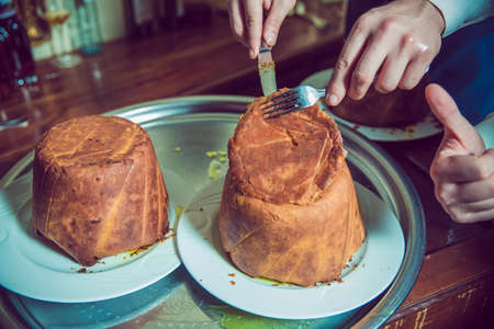 Shah pilaf. Khan pilaf in a pita. Traditional oriental dish . on tableware . Azerbaijan , Baku . Shah Pilaf with fire on a table in restaurant .の写真素材