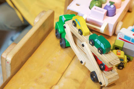 Close-up of a wooden toy truck with a painted on the wooden table. Educational toys for little kids....
