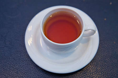 White Glass cup isolated on a blue background with clipping path. Front view . Tea cup over blue background .の写真素材